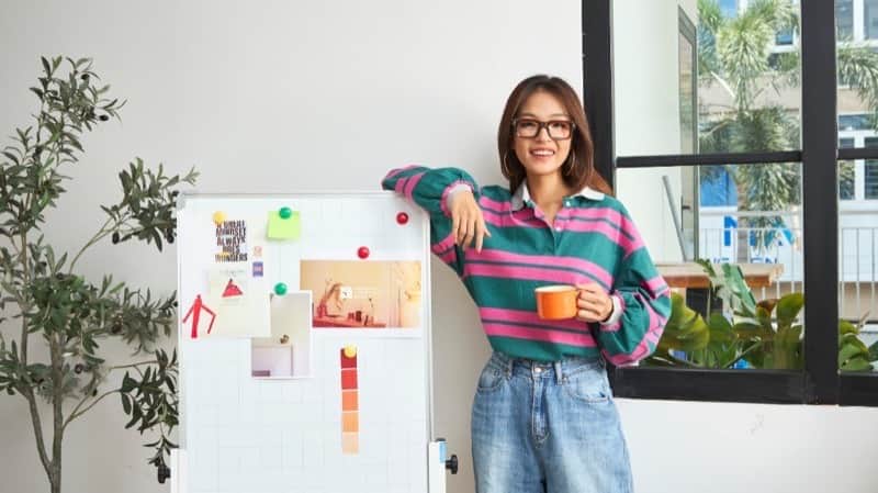 Creative professional using AI creative tools for ad teams beside a mood board
